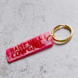 Raise Hell Cowgirl Pink Keychain Angled View