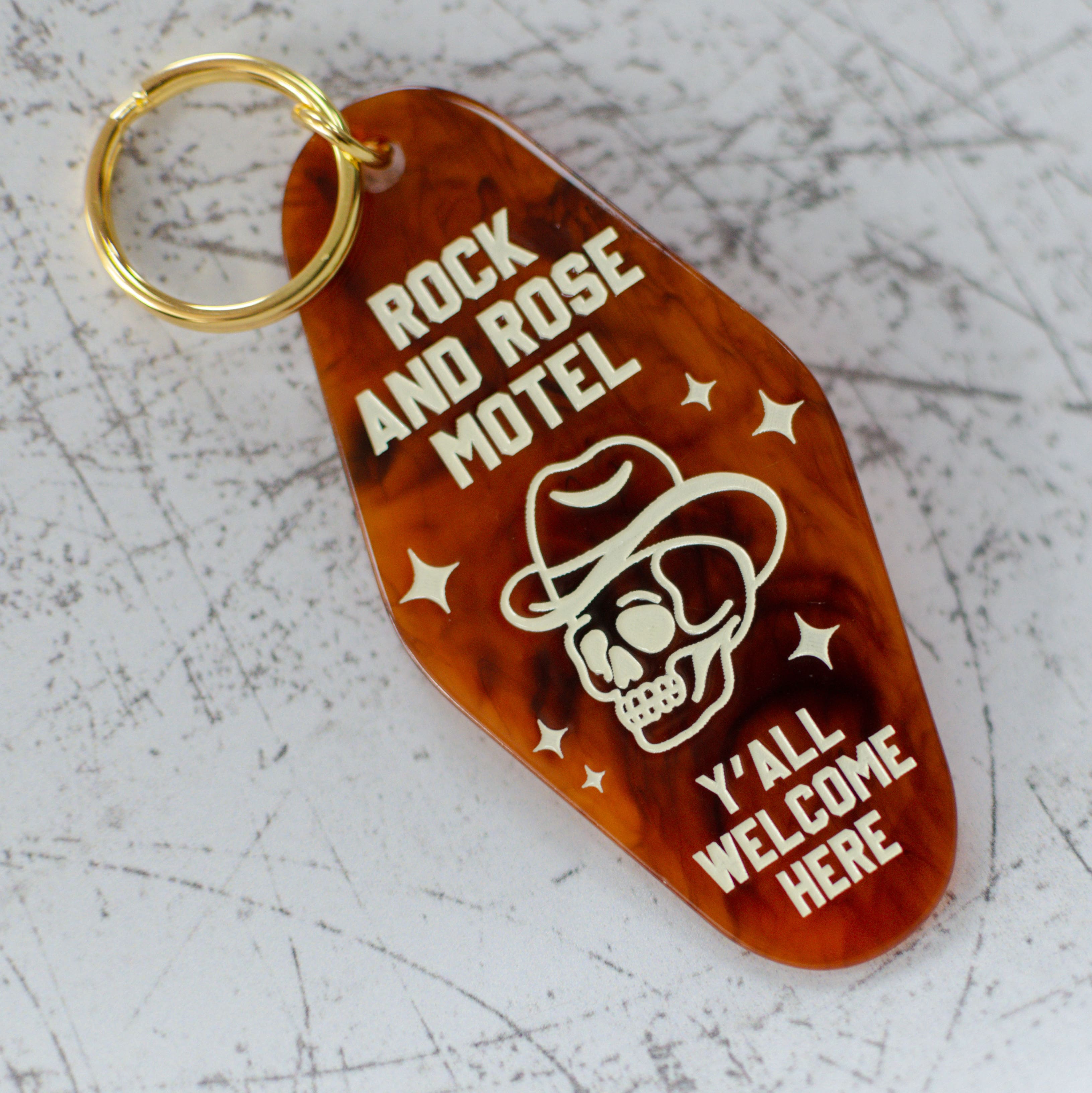 Rock And Rose Motel Keychain In A Motel Key Style Angled View