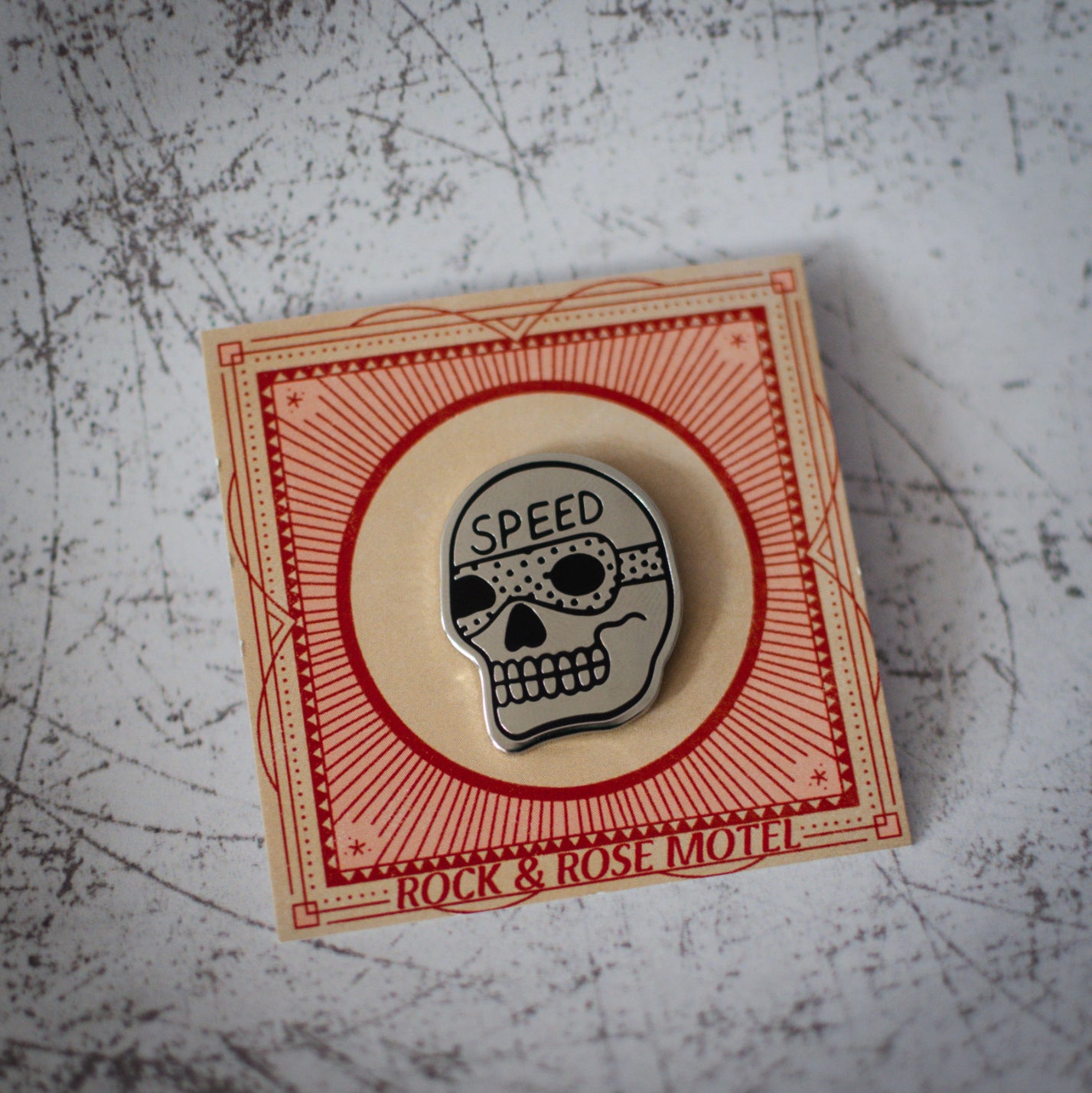 American Traditional Speed Skull Design Enamel Pin in Packaging