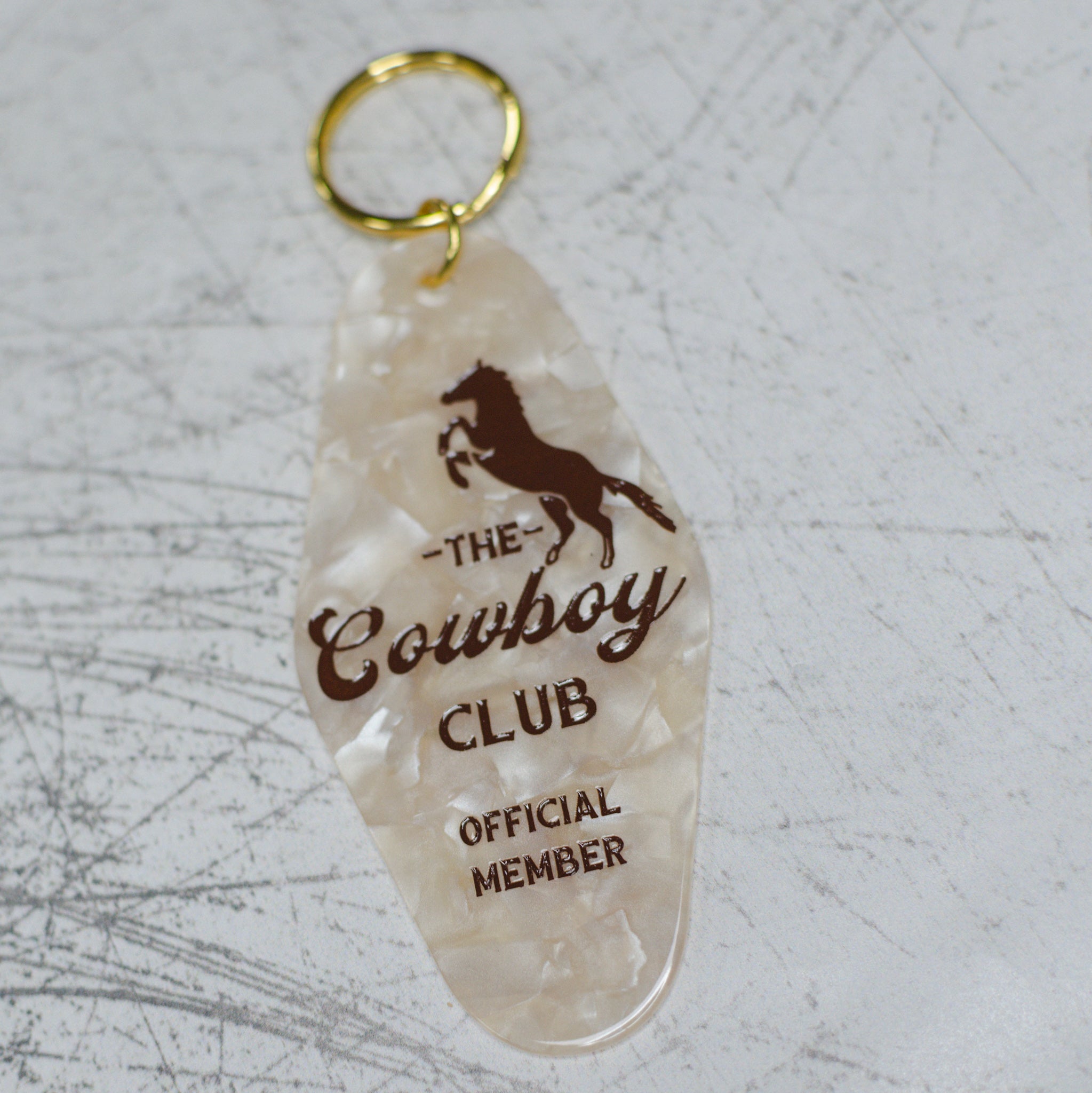 The Cowboy Club Official Member Motel Keychain Angled Front View