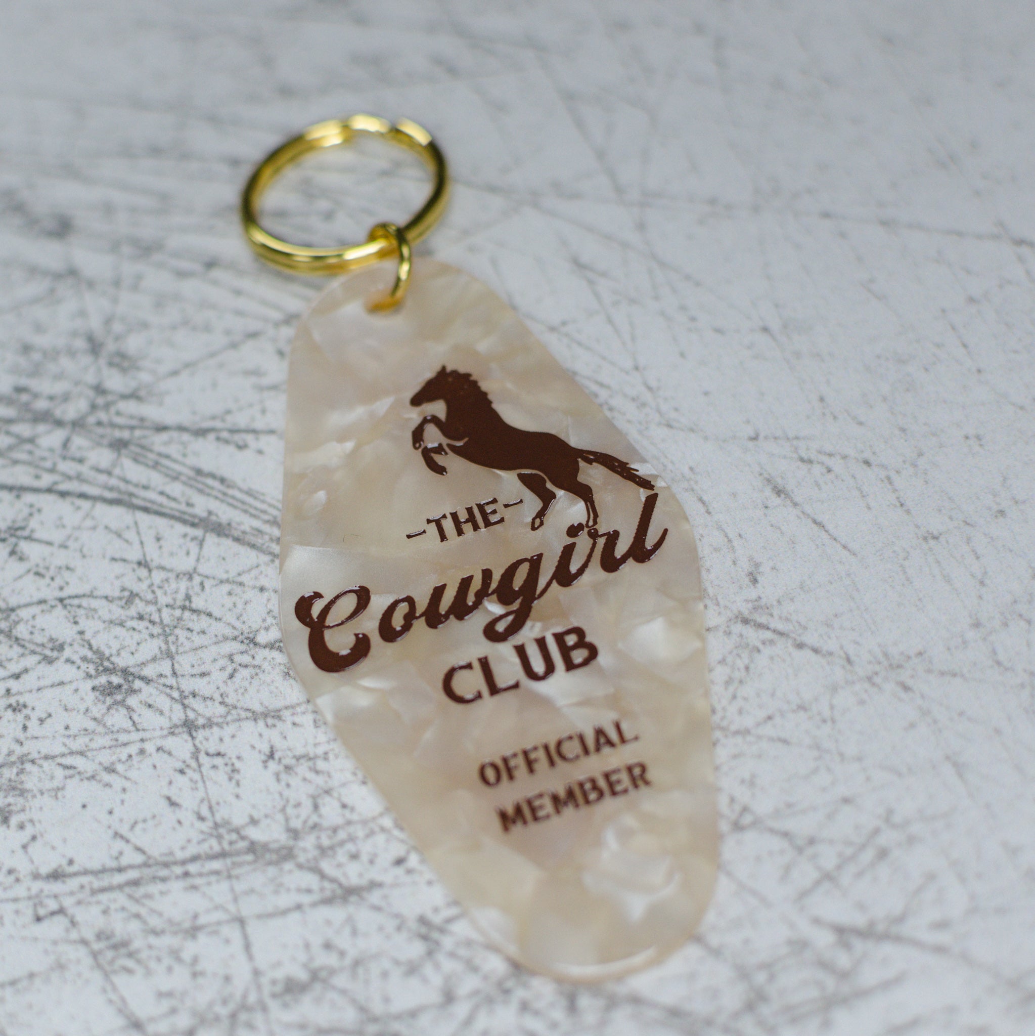 The Cowgirl Club Official Member Keychain Angled View