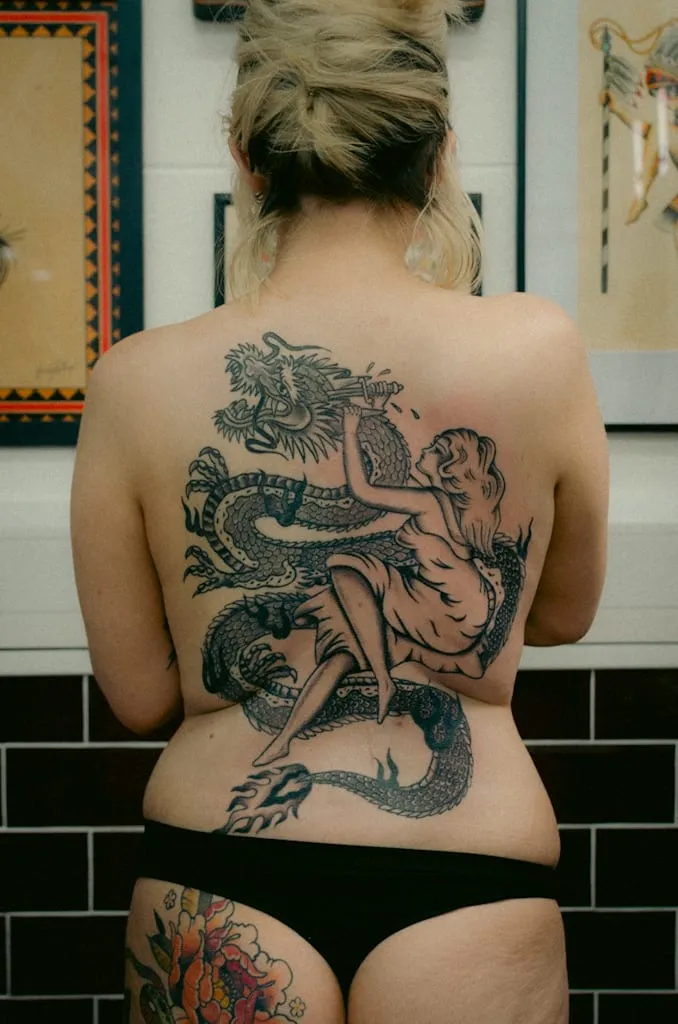 Traditional black and grey dragon and woman back peice