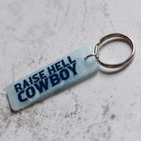Raise Hell Cowboy Blue Keychain Angled View